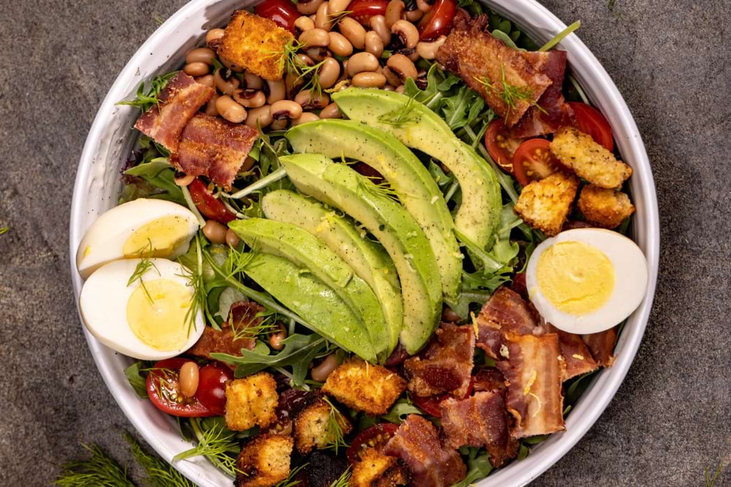 Cobb salad with Knotts eggs and peeps with avocado, bacon, beans, croutons, cherry tomato and greens