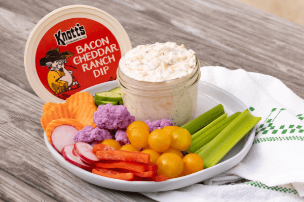 bacon cheddar ranch dip with plate of veggies