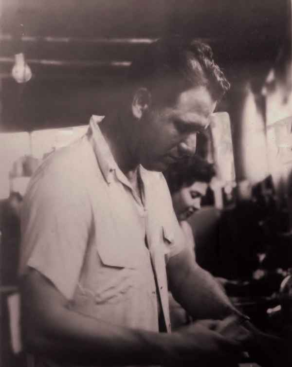old photo of cedric knotts working in the kitchen to make sandwiches