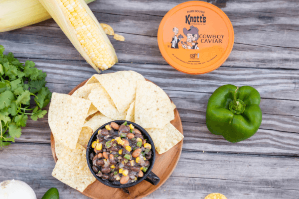 cowboy caviar on a table with ingredients and chips