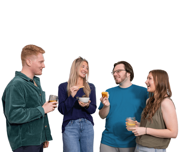 a cutout of four friends gathered and eating knott's together