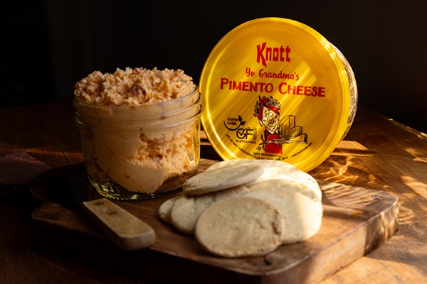 knott yo grandmas pimento cheese next to a board with crackers