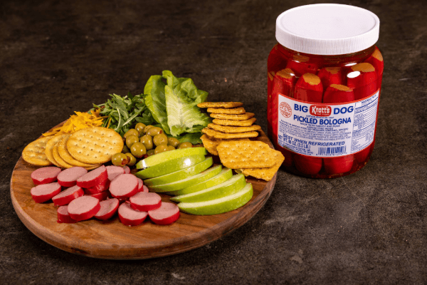 pickled bologna next to a charcuterie board
