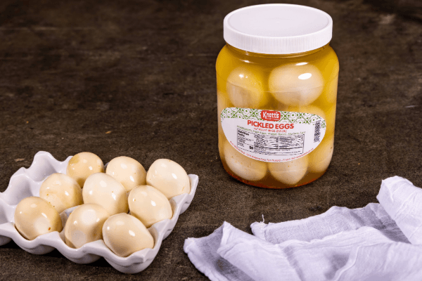 knotts pickled eggs sitting by a carton of pickled eggs
