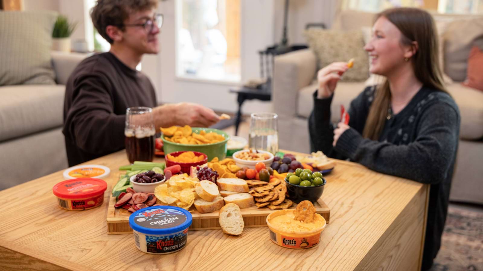 two friends sitting and eating knotts together
